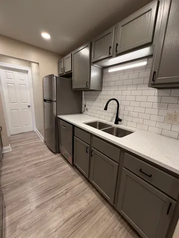 a kitchen with refrigerator and sink