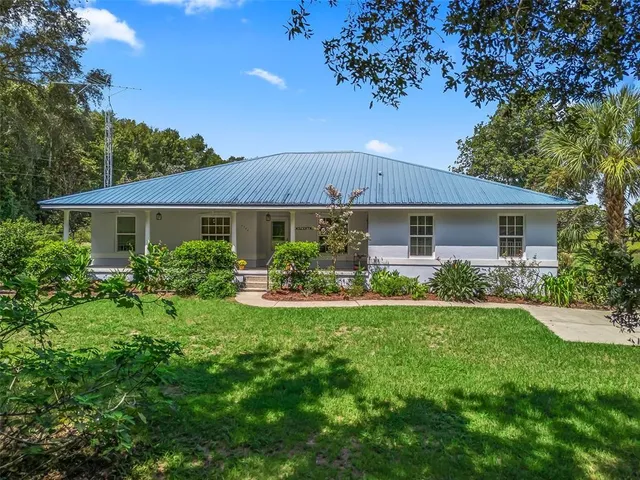 a front view of a house with a yard and porch