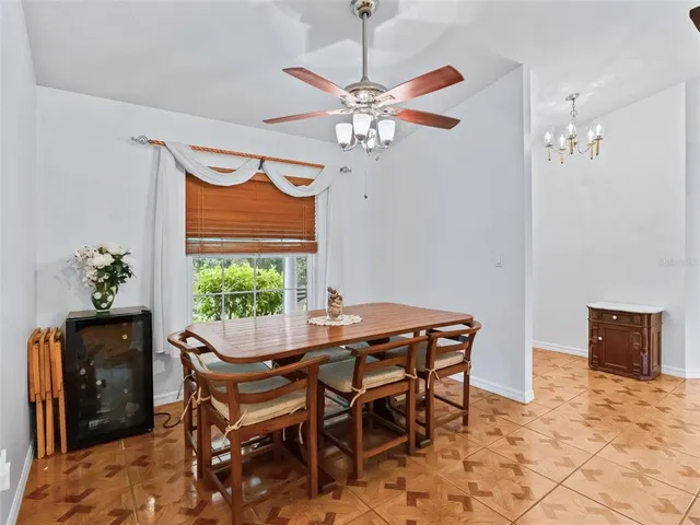 a view of a dining room with furniture and a potted plant