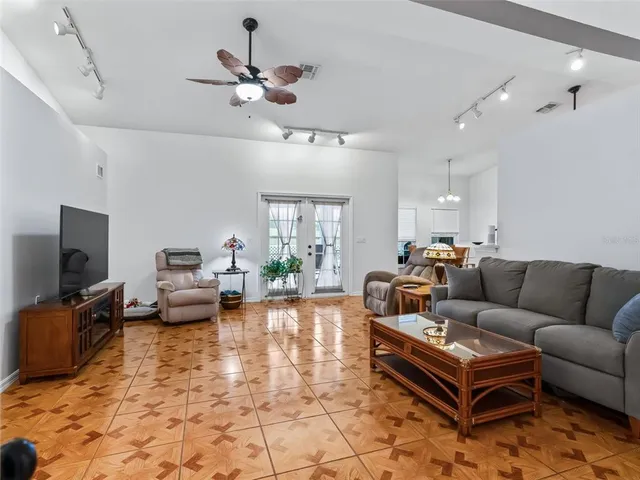a living room with furniture and a bookshelf