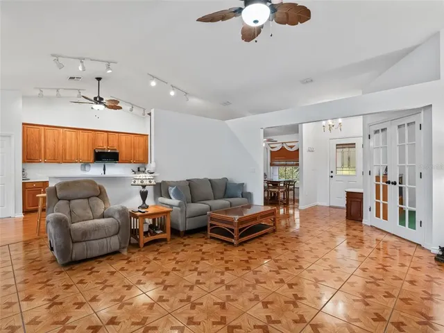 a living room with furniture and a book shelf