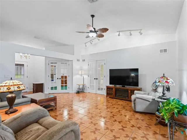a bedroom with a bed and a ceiling fan