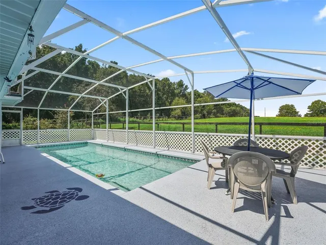 a house is sitting in middle od the grass