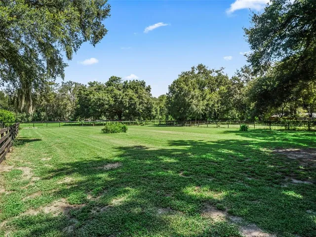 a view of house with yard and green space
