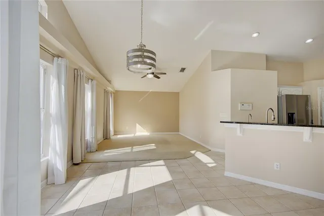 a living room with furniture a ceiling fan and a window