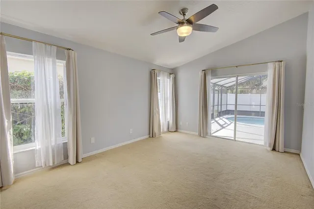 a view of an empty room and a ceiling fan