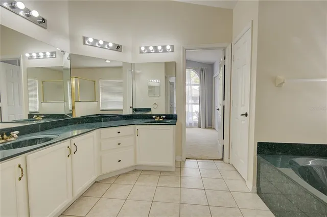 a bathroom with a tub a window and a shower