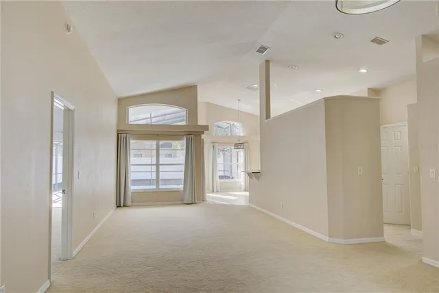 a view of an empty room with a fireplace and a window