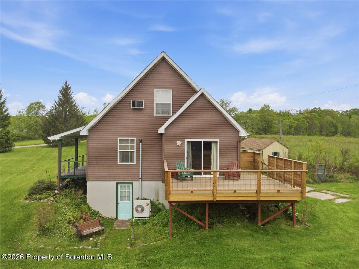 5231 Fiddle Lake Road Thompson, PA 18465 - Photo 25 of 34 a aerial view of a house with a yard and deck