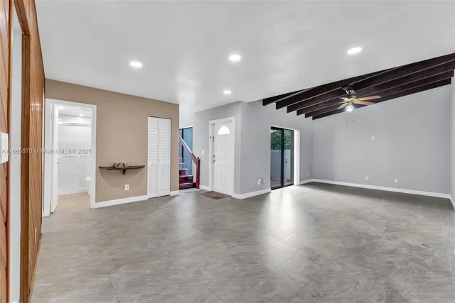 a kitchen with cabinets appliances a sink and a window