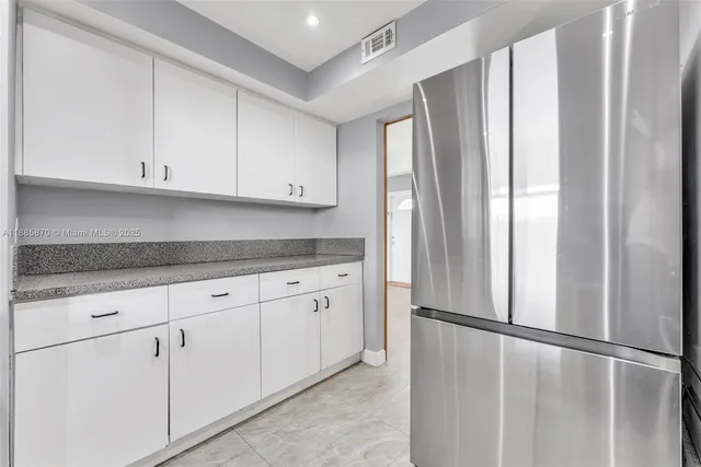 a living room with furniture and a book shelf