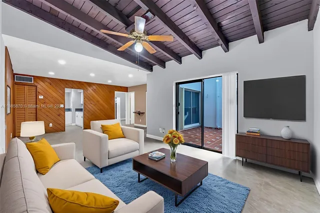 a view of a livingroom with a ceiling fan and window