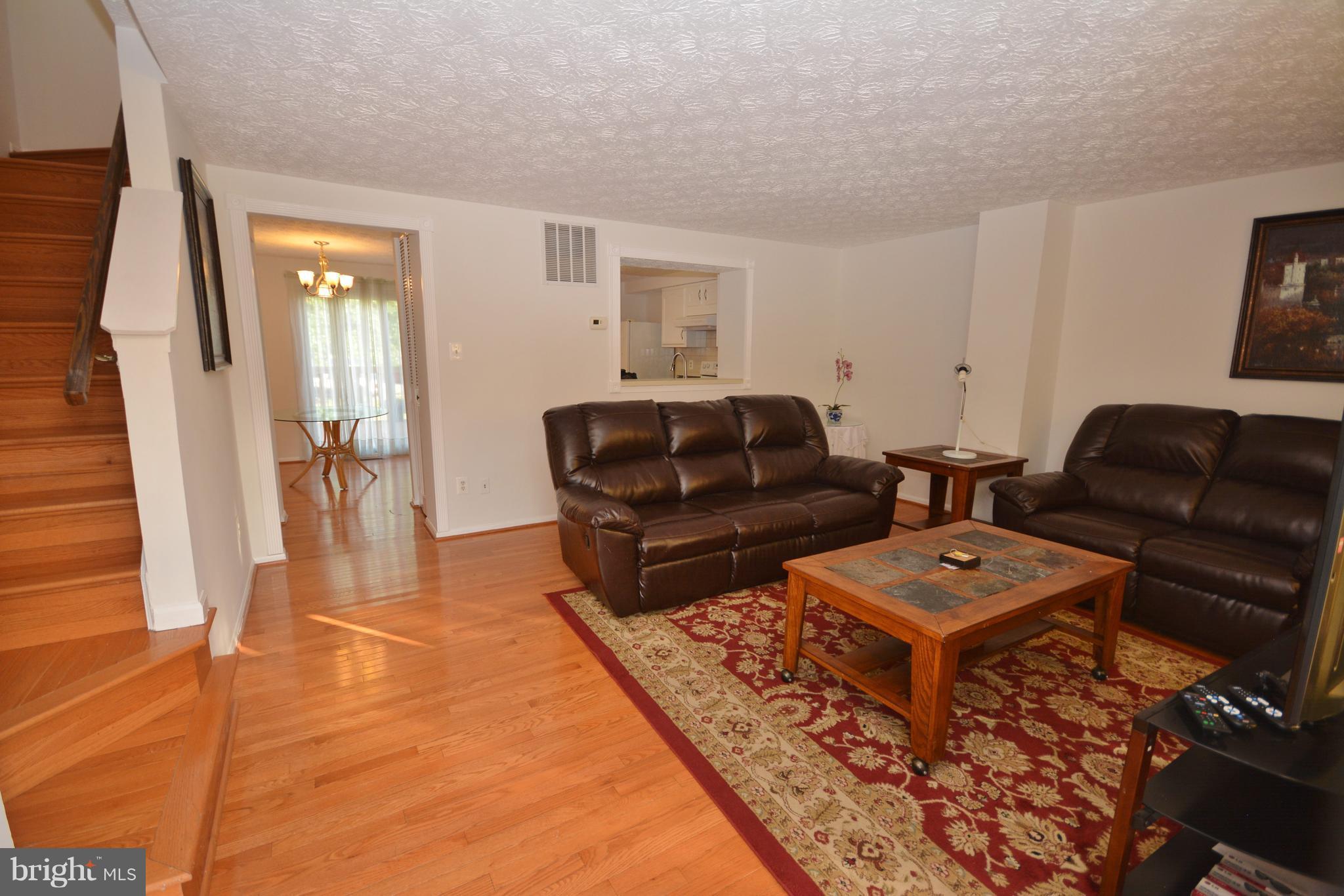 7407 Aspenpark Road Lorton, VA 22079 - Photo 3 of 12 a living room with furniture and wooden floor