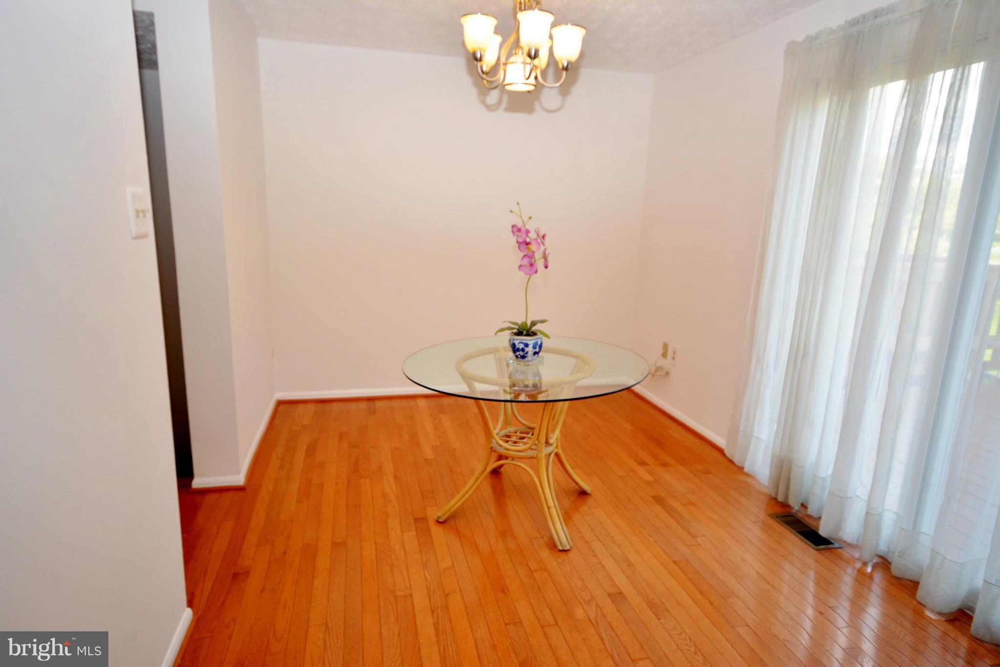 7407 Aspenpark Road Lorton, VA 22079 - Photo 6 of 12 a bedroom with a bed and a chandelier