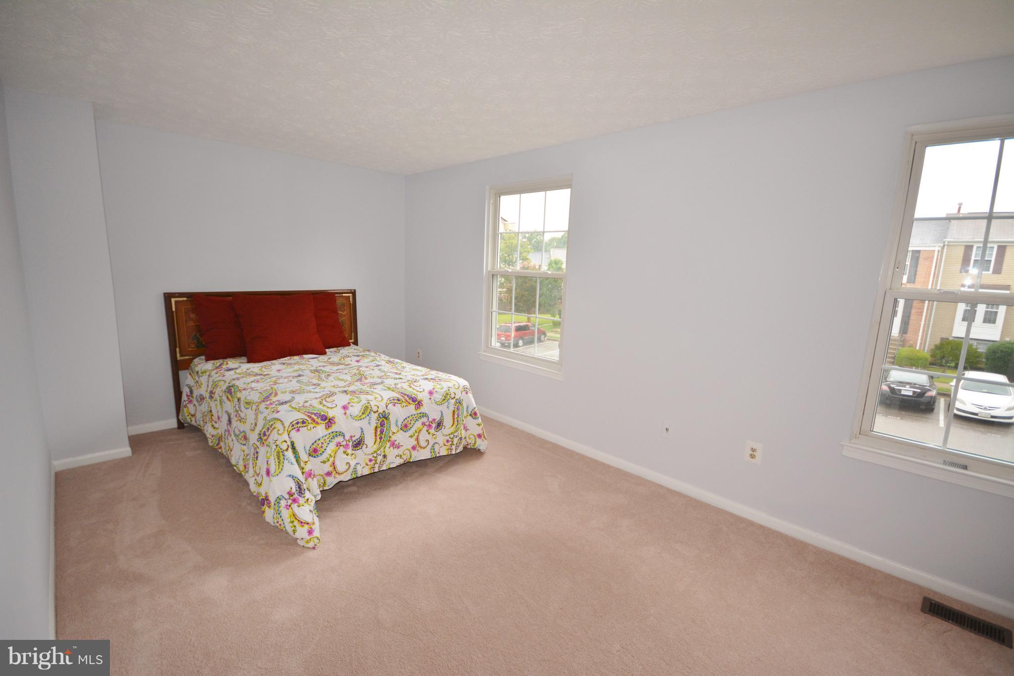7407 Aspenpark Road Lorton, VA 22079 - Photo 9 of 12 a bedroom with a bed and a window