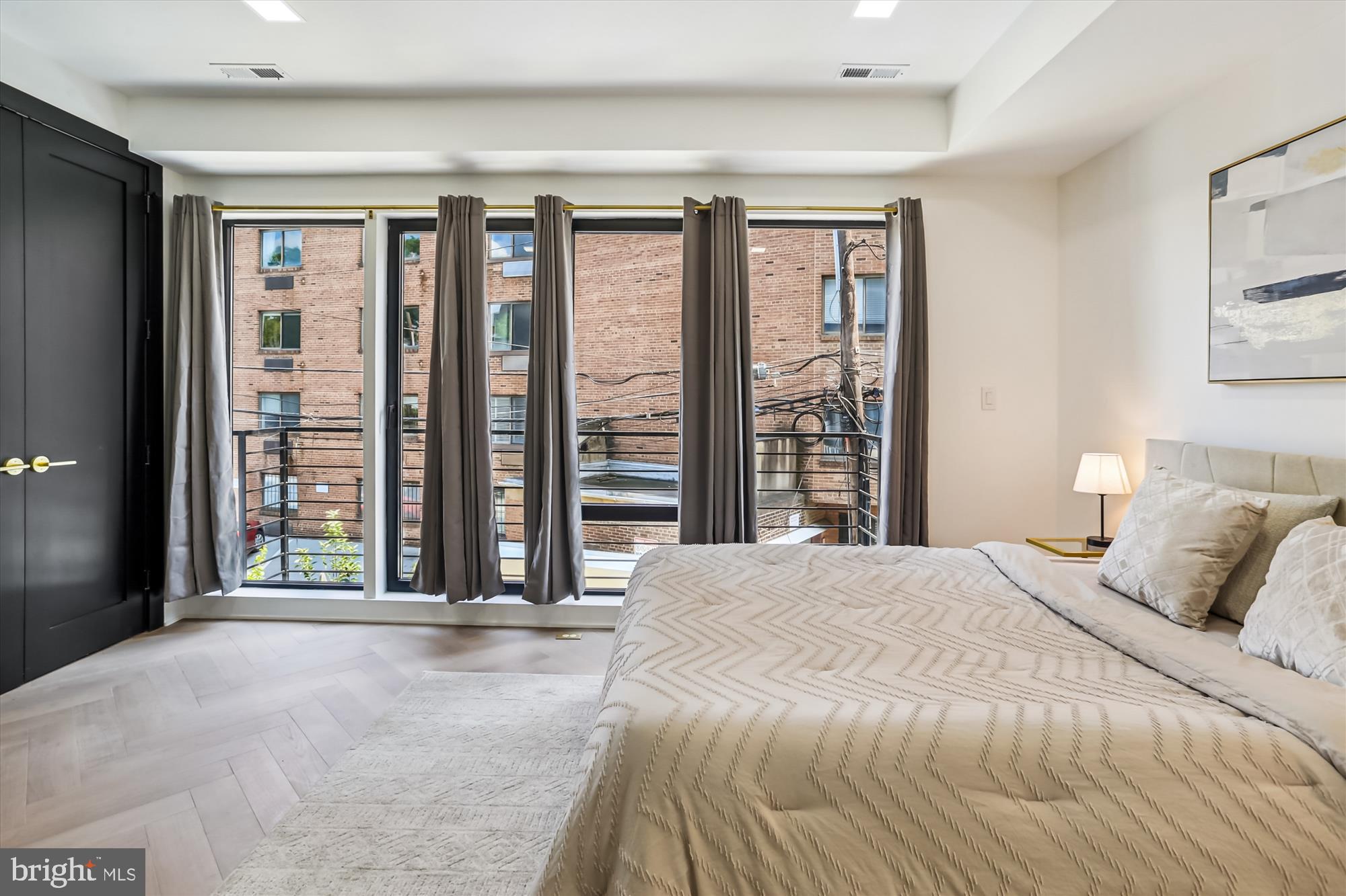 1832 Florida Avenue Northwest Washington, DC 20009 - Photo 20 of 60 a bedroom with a large bed and a large window