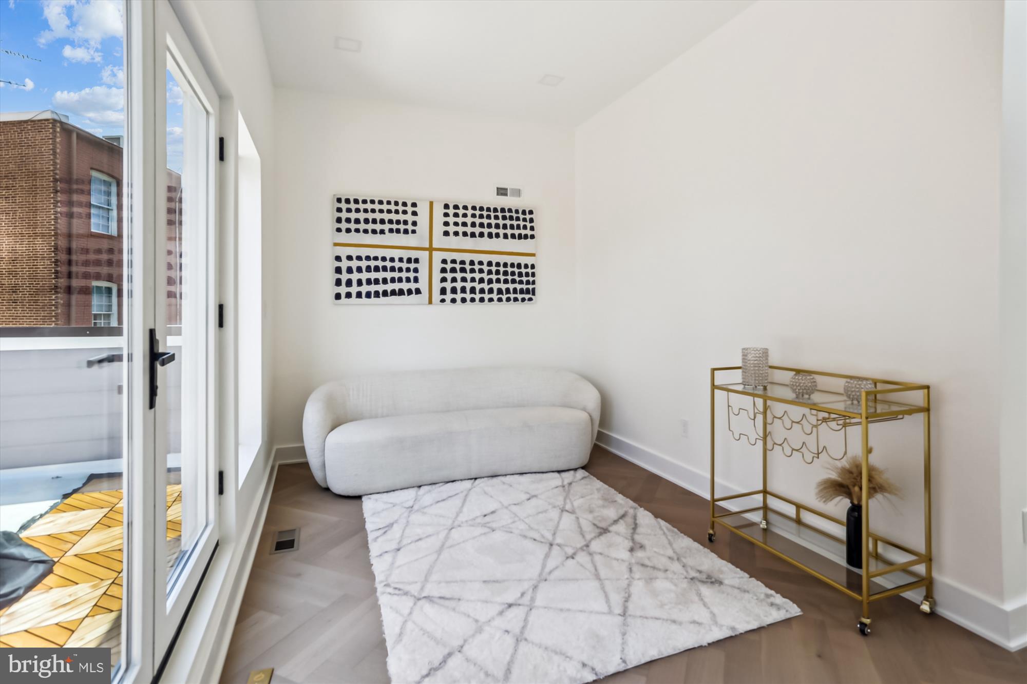 1832 Florida Avenue Northwest Washington, DC 20009 - Photo 36 of 60 a bedroom with a bed and wooden floor