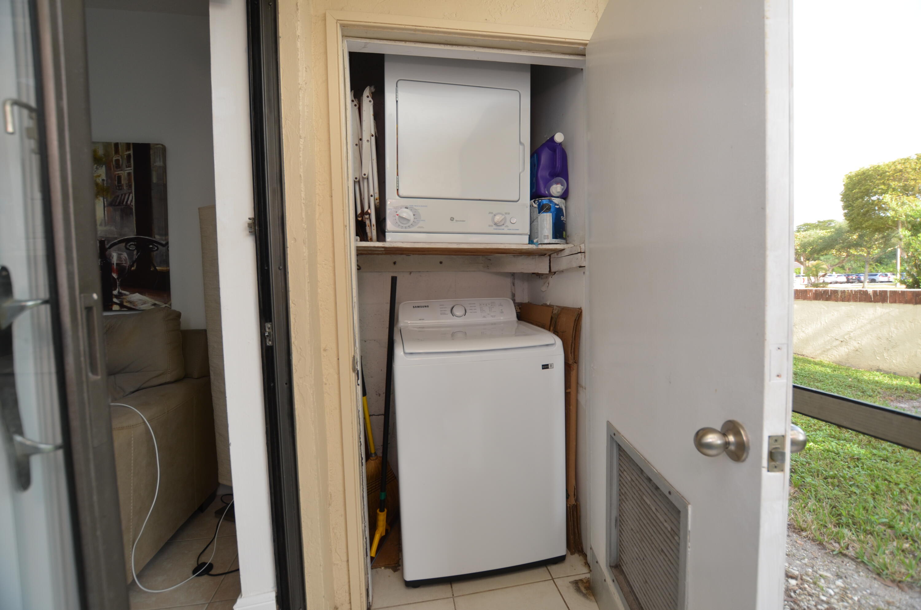 6649 Somerset Drive, Unit 102 Boca Raton, FL 33433 - Photo 17 of 19 a utility room with dryer and washer