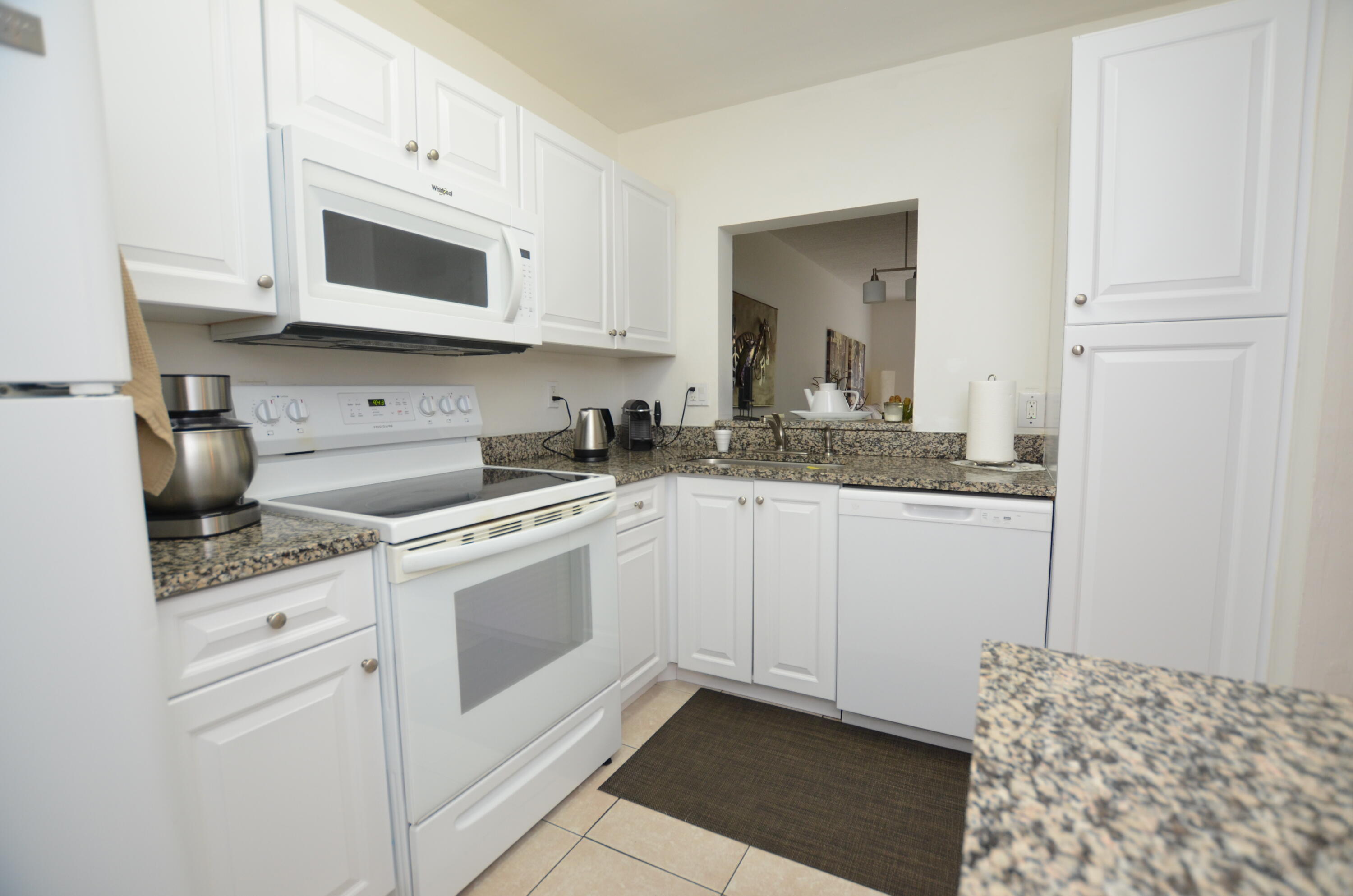 6649 Somerset Drive, Unit 102 Boca Raton, FL 33433 - Photo 3 of 19 a kitchen with stainless steel appliances granite countertop a sink a stove and cabinets