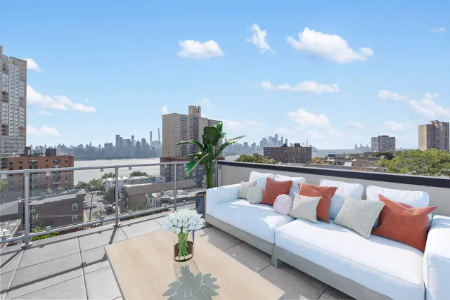 a balcony with outdoor seating and city view