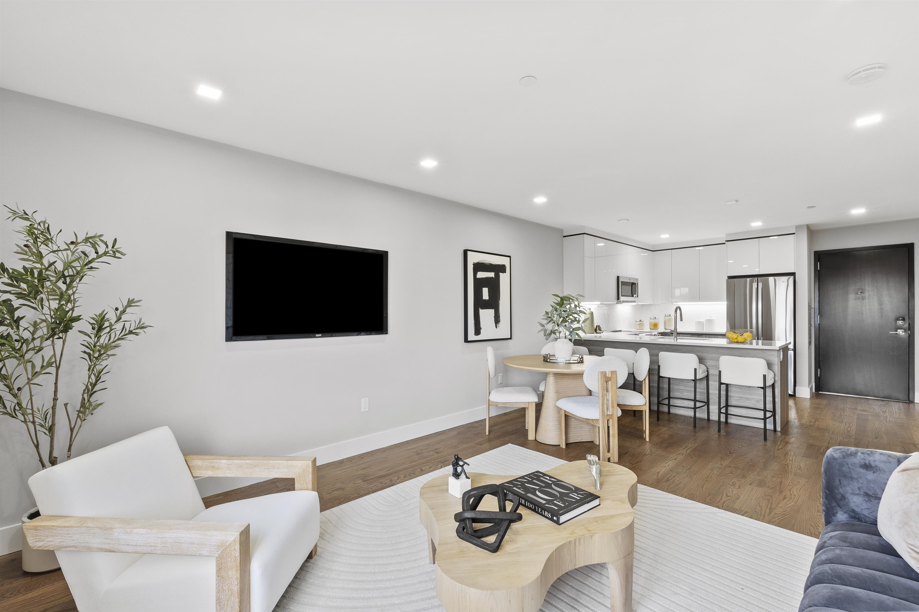 60-64 68th Street, Unit 208 Guttenberg, NJ 07093 - Photo 11 of 29 a living room with furniture and a flat screen tv