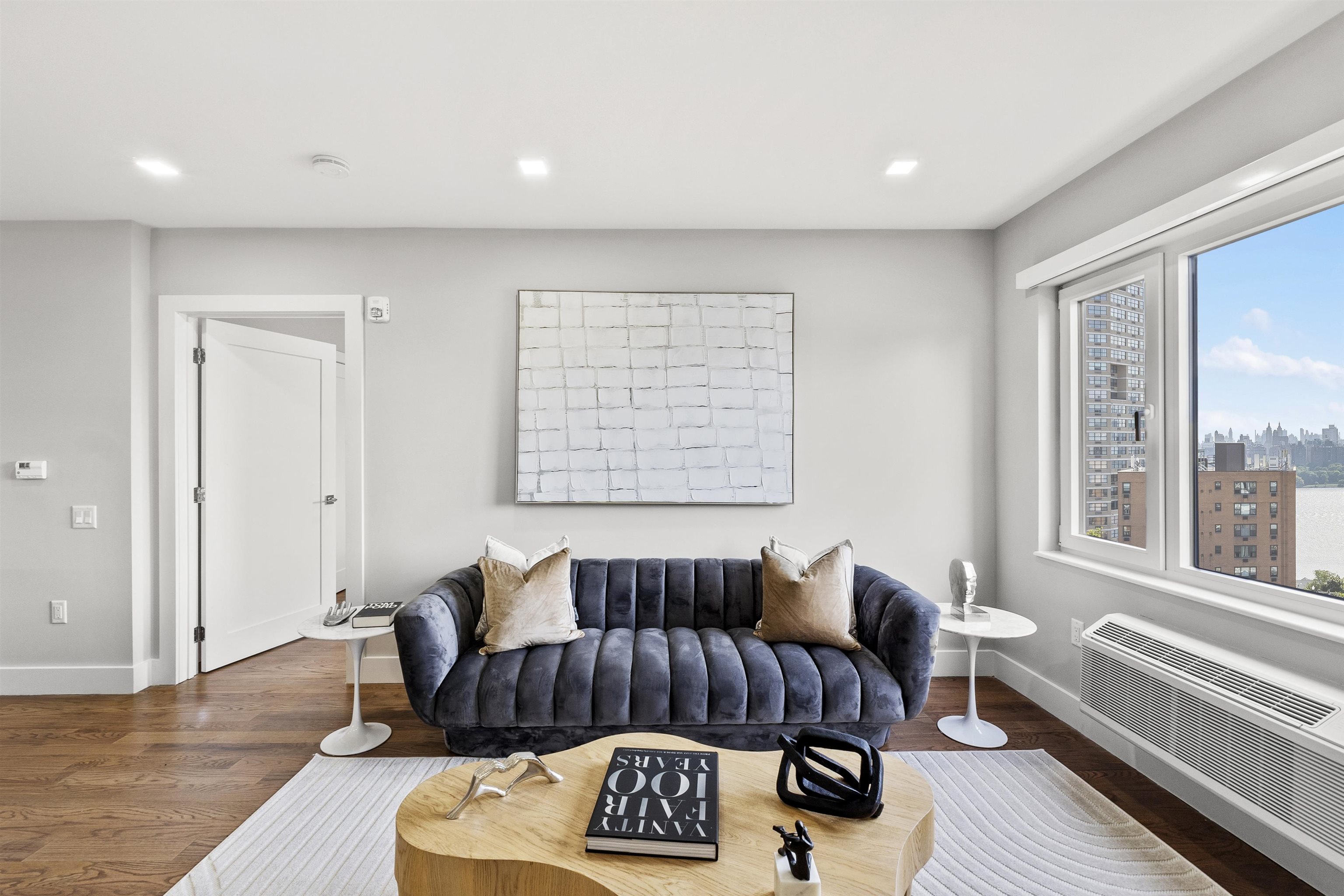 60-64 68th Street, Unit 208 Guttenberg, NJ 07093 - Photo 14 of 29 a view of a livingroom with furniture and wooden floor