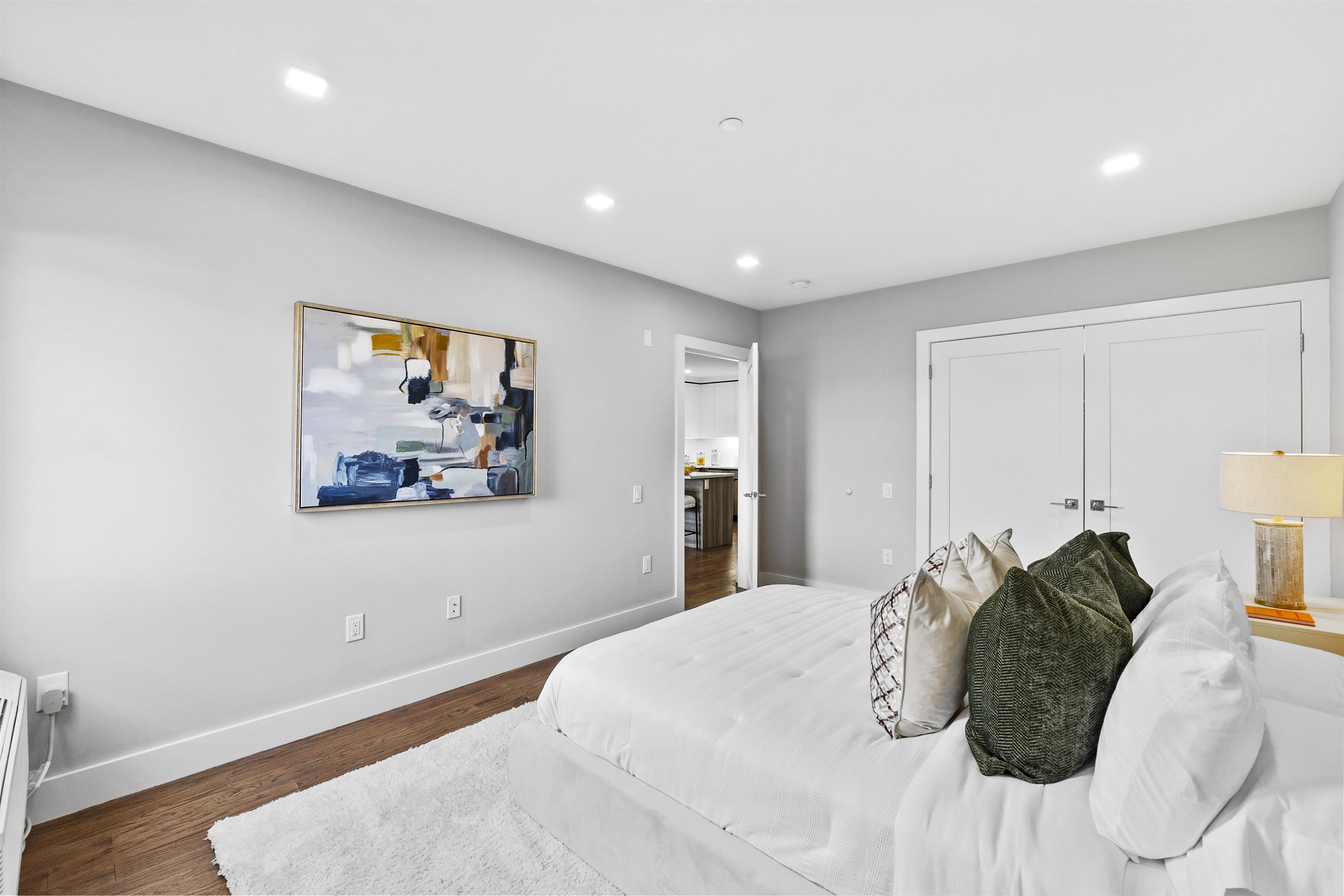 60-64 68th Street, Unit 208 Guttenberg, NJ 07093 - Photo 15 of 29 a bedroom with a bed and a painting on the wall