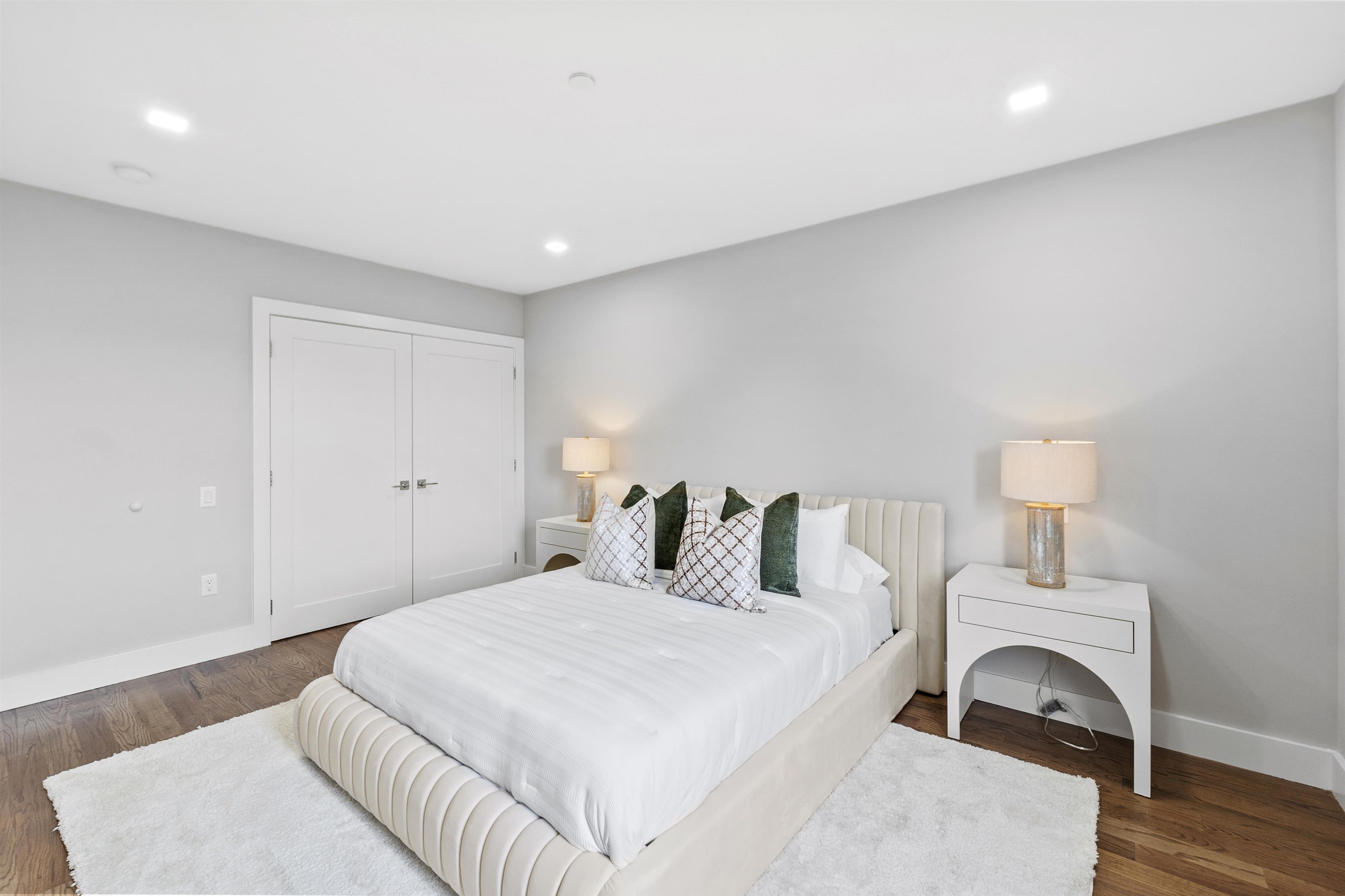 60-64 68th Street, Unit 208 Guttenberg, NJ 07093 - Photo 16 of 29 a bedroom with a bed and a lamp