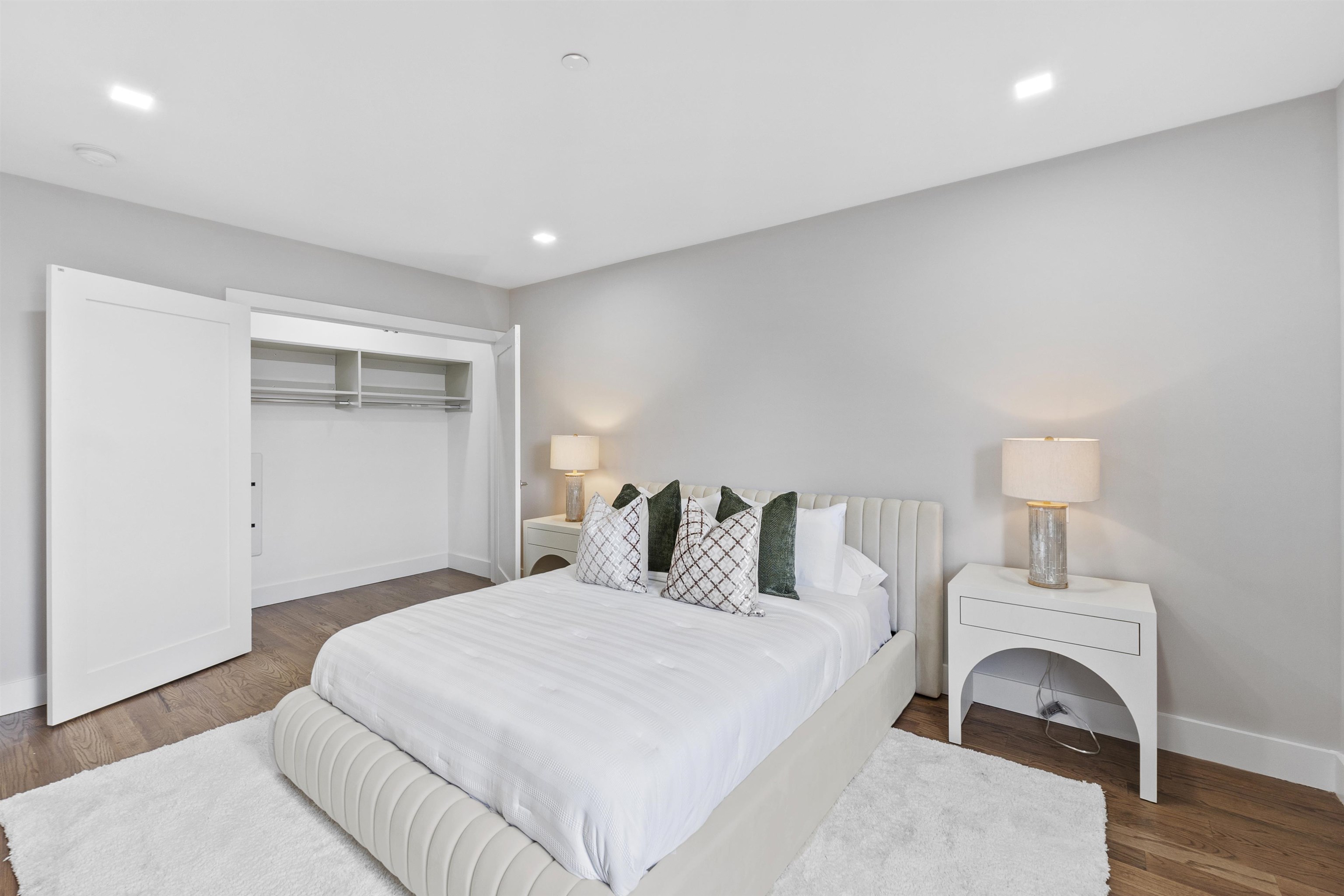 60-64 68th Street, Unit 208 Guttenberg, NJ 07093 - Photo 18 of 29 a bedroom with a bed and a white wall painting