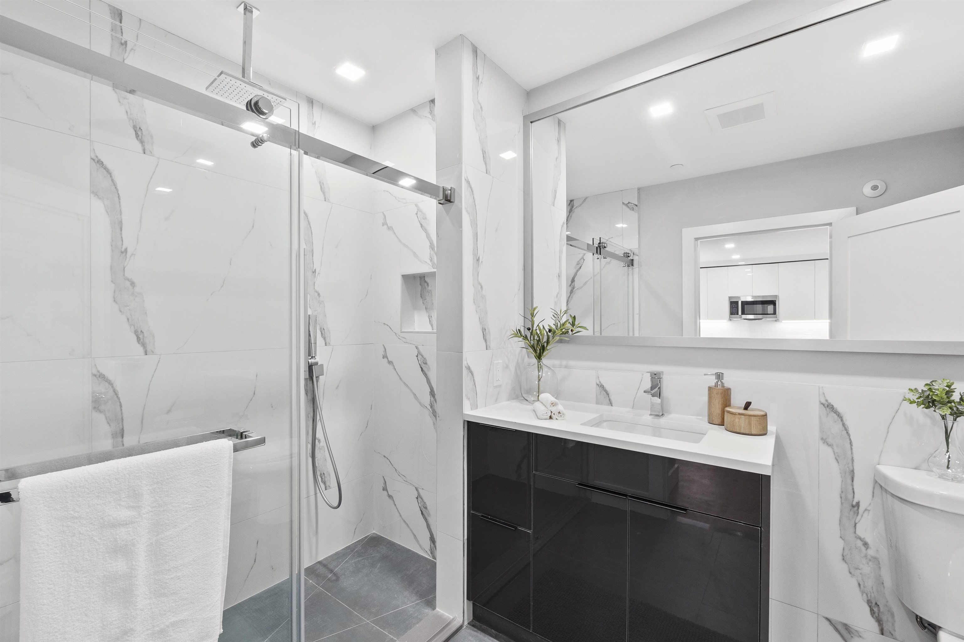 60-64 68th Street, Unit 208 Guttenberg, NJ 07093 - Photo 20 of 29 a bathroom with a double vanity sink mirror double shower and a bathtub