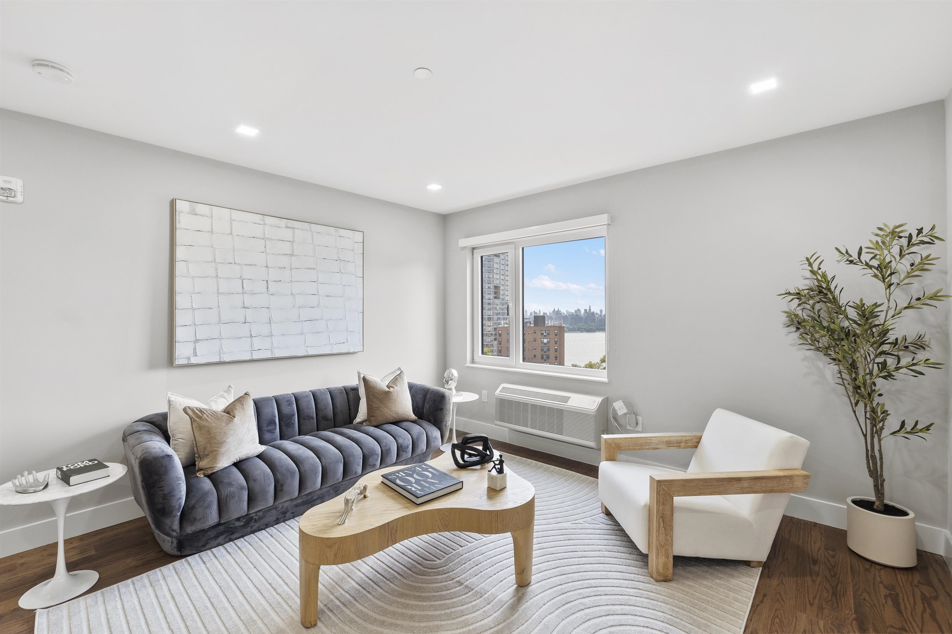 60-64 68th Street, Unit 208 Guttenberg, NJ 07093 - Photo 22 of 29 a living room with furniture and a large window