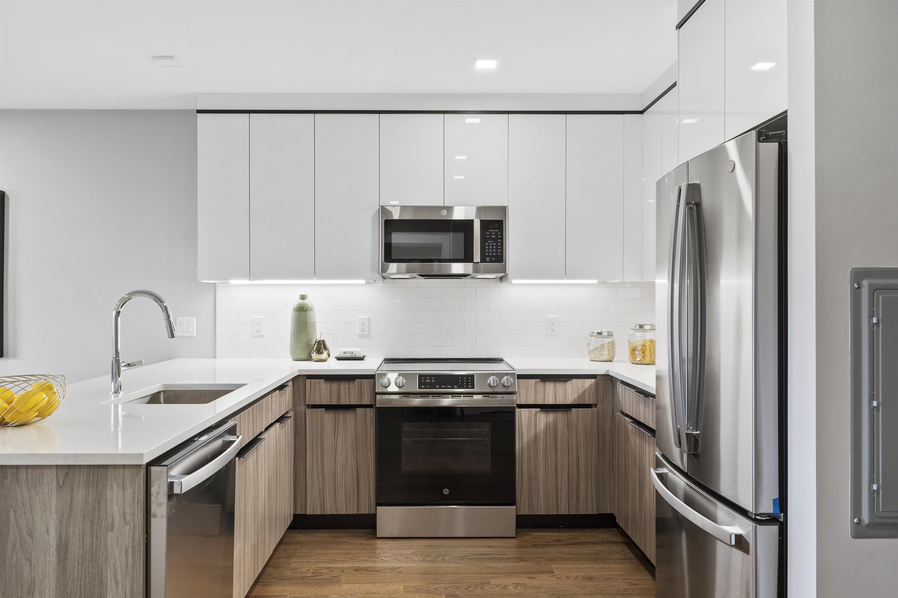 60-64 68th Street, Unit 208 Guttenberg, NJ 07093 - Photo 5 of 29 a kitchen with stainless steel appliances a stove a sink and a refrigerator