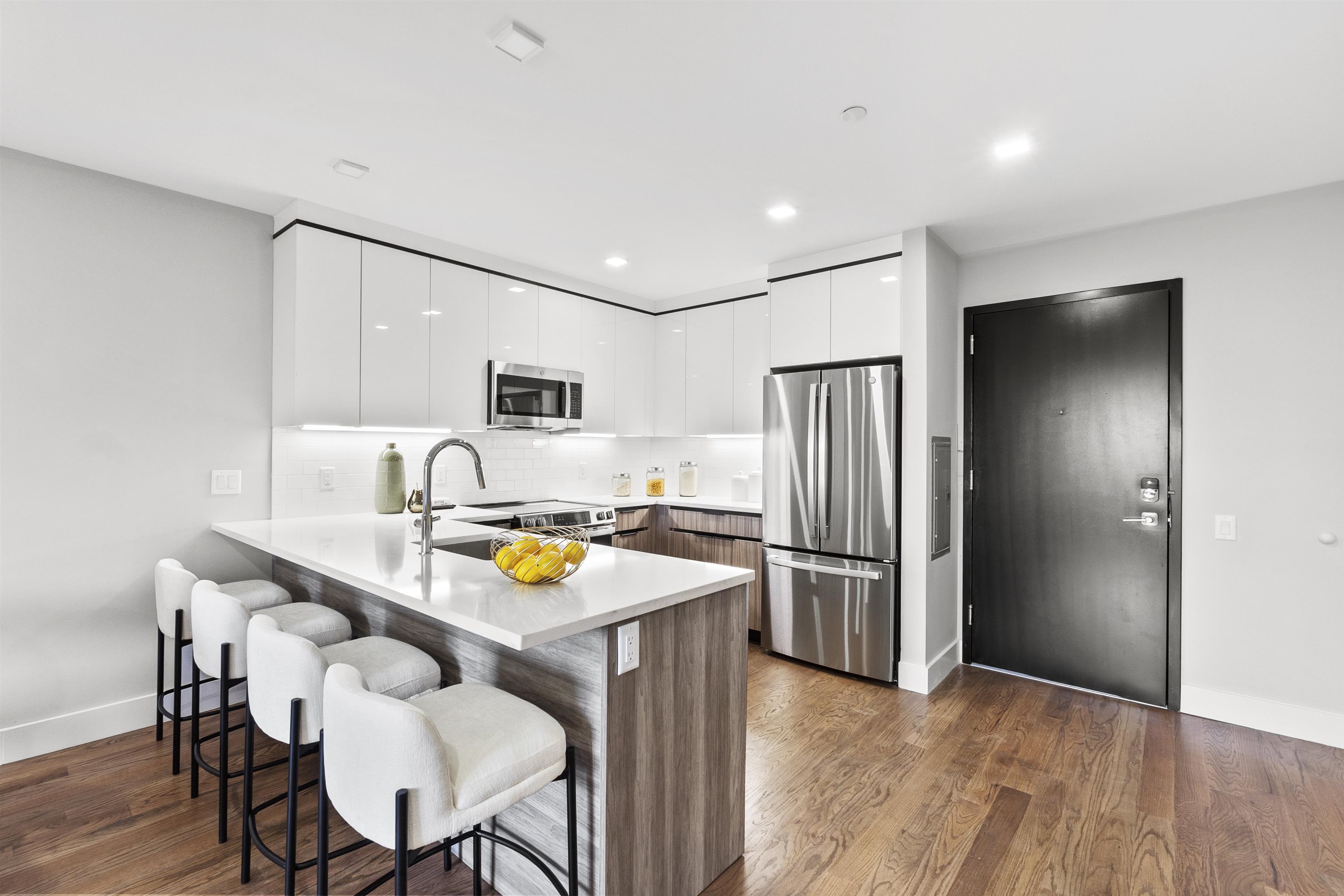 60-64 68th Street, Unit 208 Guttenberg, NJ 07093 - Photo 7 of 29 a kitchen with stainless steel appliances granite countertop a refrigerator and a stove top oven