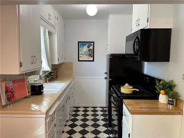 a kitchen with a sink a stove and a refrigerator