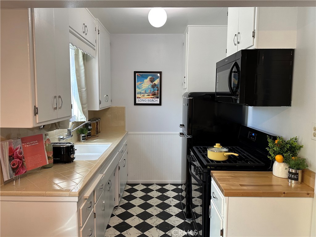 219 Esperanza Avenue, Unit 7 Long Beach, CA 90802 - Photo 7 of 13 a kitchen with a sink a stove and a refrigerator