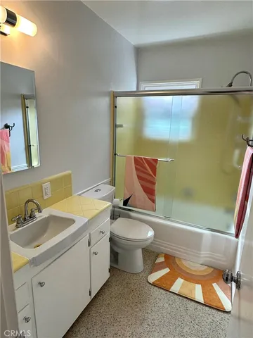 a bathroom with a toilet a sink and bathtub