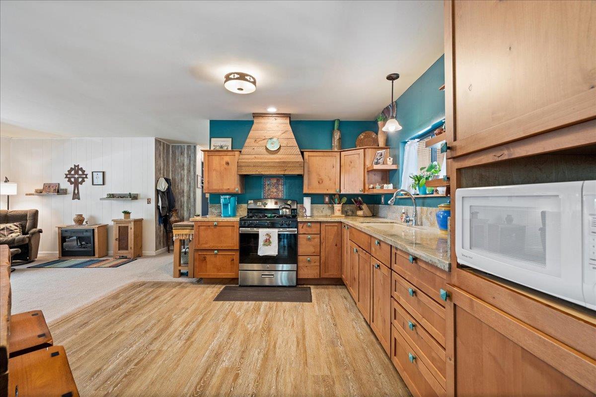 4420 Pleasant Valley Road, Unit 131 Diamond Springs, CA 95619 - Photo 13 of 30 a kitchen with stainless steel appliances kitchen island granite countertop a stove a sink and a refrigerator