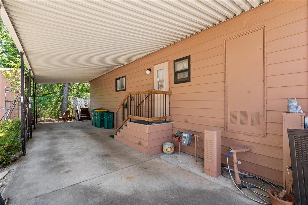 4420 Pleasant Valley Road, Unit 131 Diamond Springs, CA 95619 - Photo 22 of 30 a view of a patio with furniture and a garage