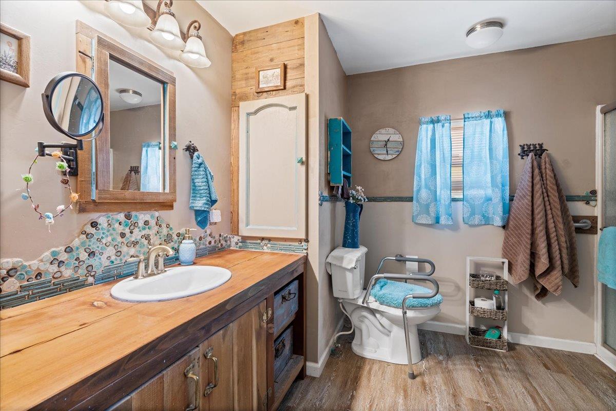 4420 Pleasant Valley Road, Unit 131 Diamond Springs, CA 95619 - Photo 8 of 30 a bathroom with a granite countertop toilet sink and mirror