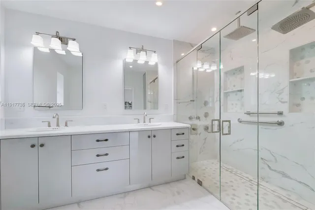 a bathroom with a double vanity sink mirror and double