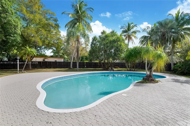 a view of a swimming pool with a yard