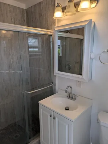 a kitchen with a refrigerator and a table