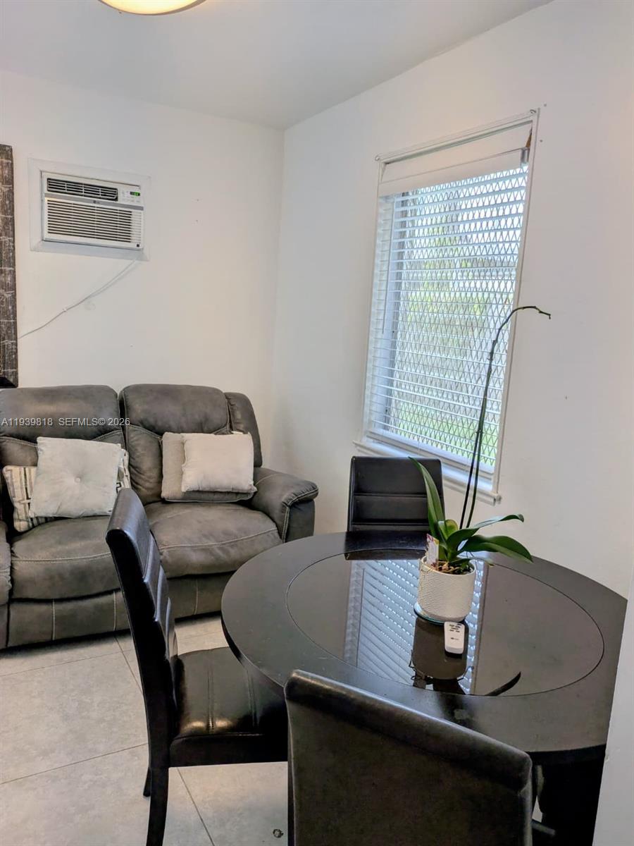 2116 Monroe Terrace Hollywood, FL 33020 - Photo 19 of 40 a living room with furniture and a table