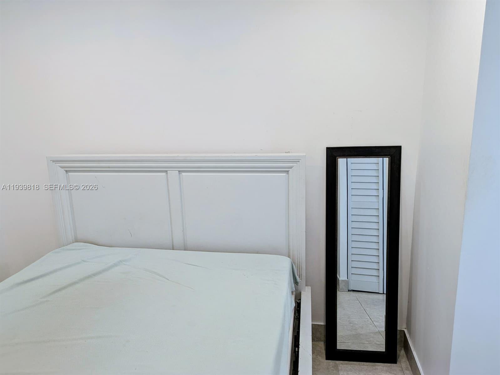 2116 Monroe Terrace Hollywood, FL 33020 - Photo 22 of 40 a bedroom with a bed and a window