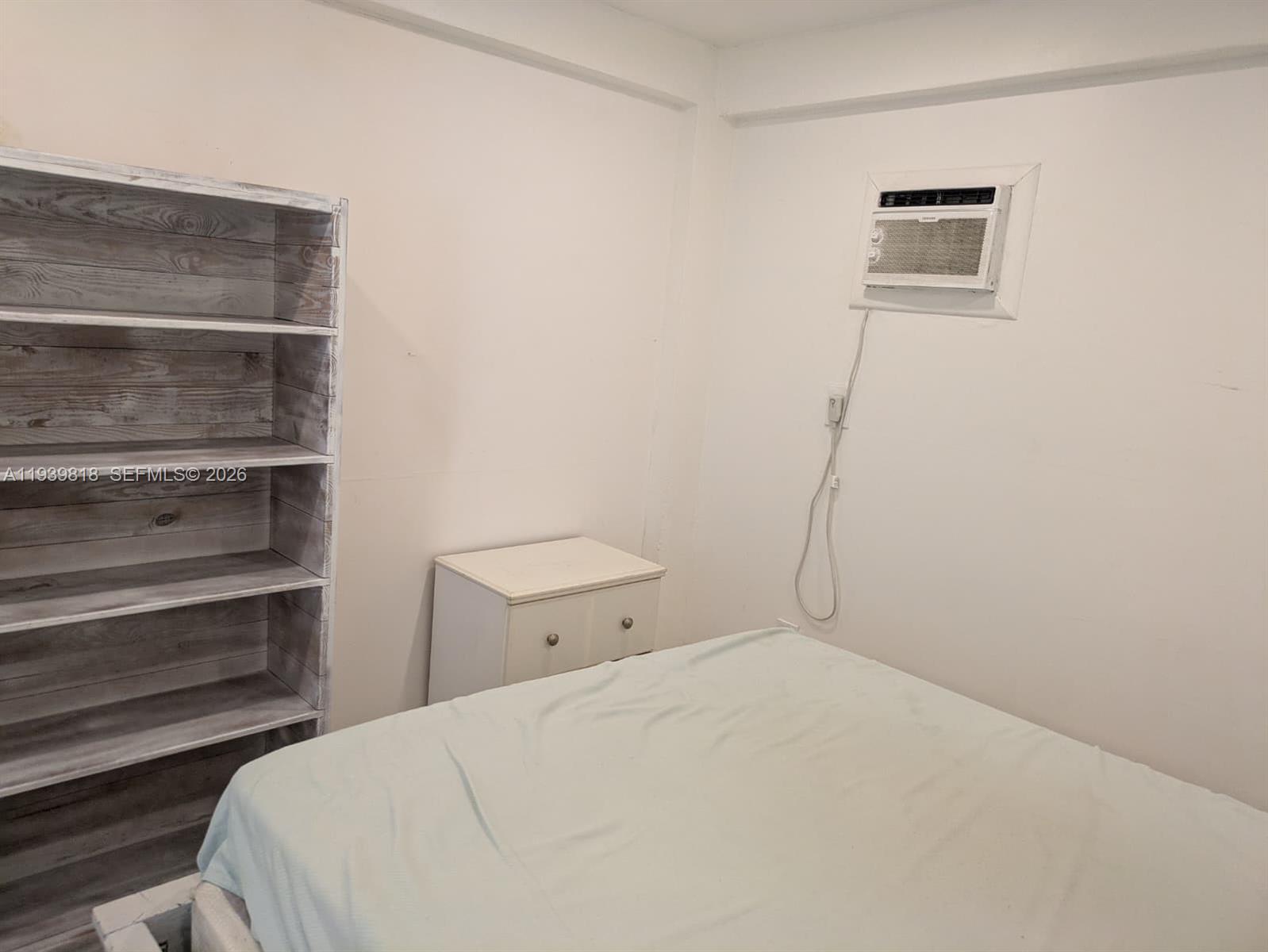 2116 Monroe Terrace Hollywood, FL 33020 - Photo 23 of 40 a bedroom with a bed and a cabinets