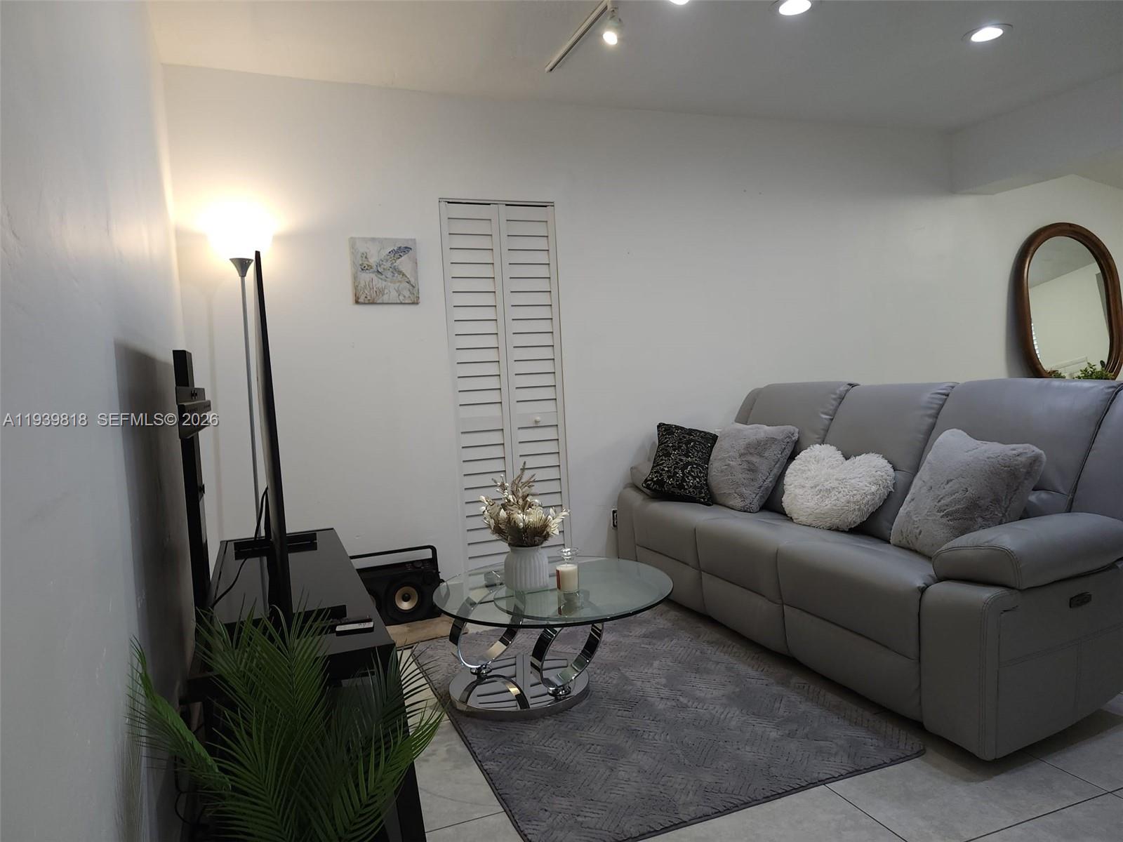 2116 Monroe Terrace Hollywood, FL 33020 - Photo 36 of 40 a living room with furniture a lamp and a potted plant