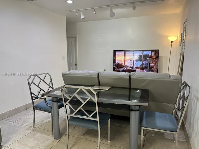 a kitchen with stainless steel appliances white cabinets and wooden floor