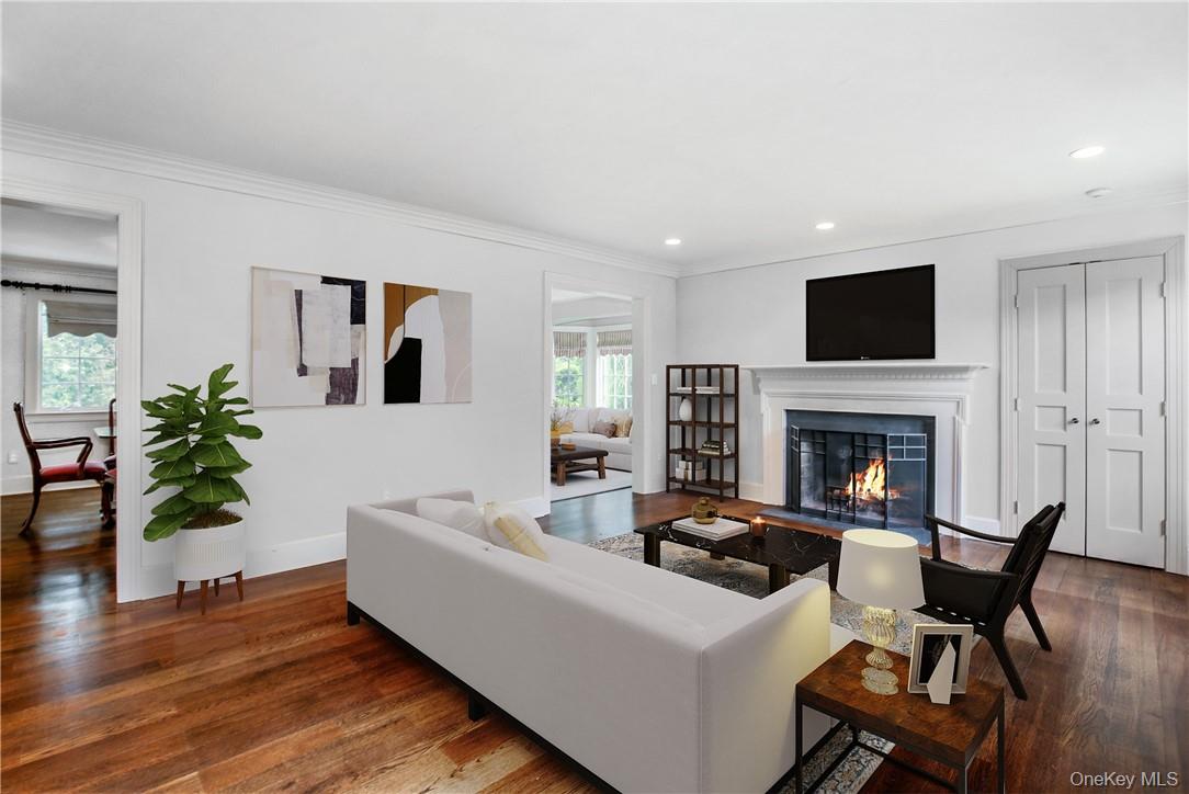 96 Mendota Avenue Rye, NY 10580 - Photo 3 of 18 Virtually staged-- Living Room with wood burning fireplace opens to Sunroom, Dining Room and Entry Foyer.