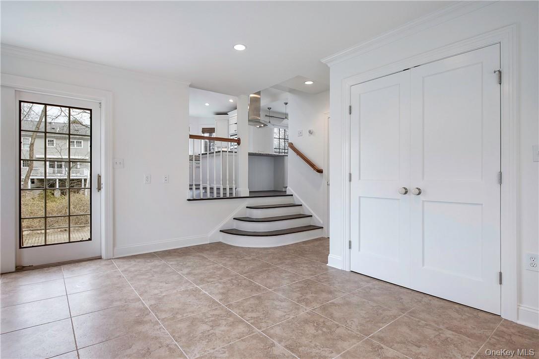96 Mendota Avenue Rye, NY 10580 - Photo 9 of 18 Step down Family Room from the Kitchen with door to driveway. Laundry closet off of Family Room.