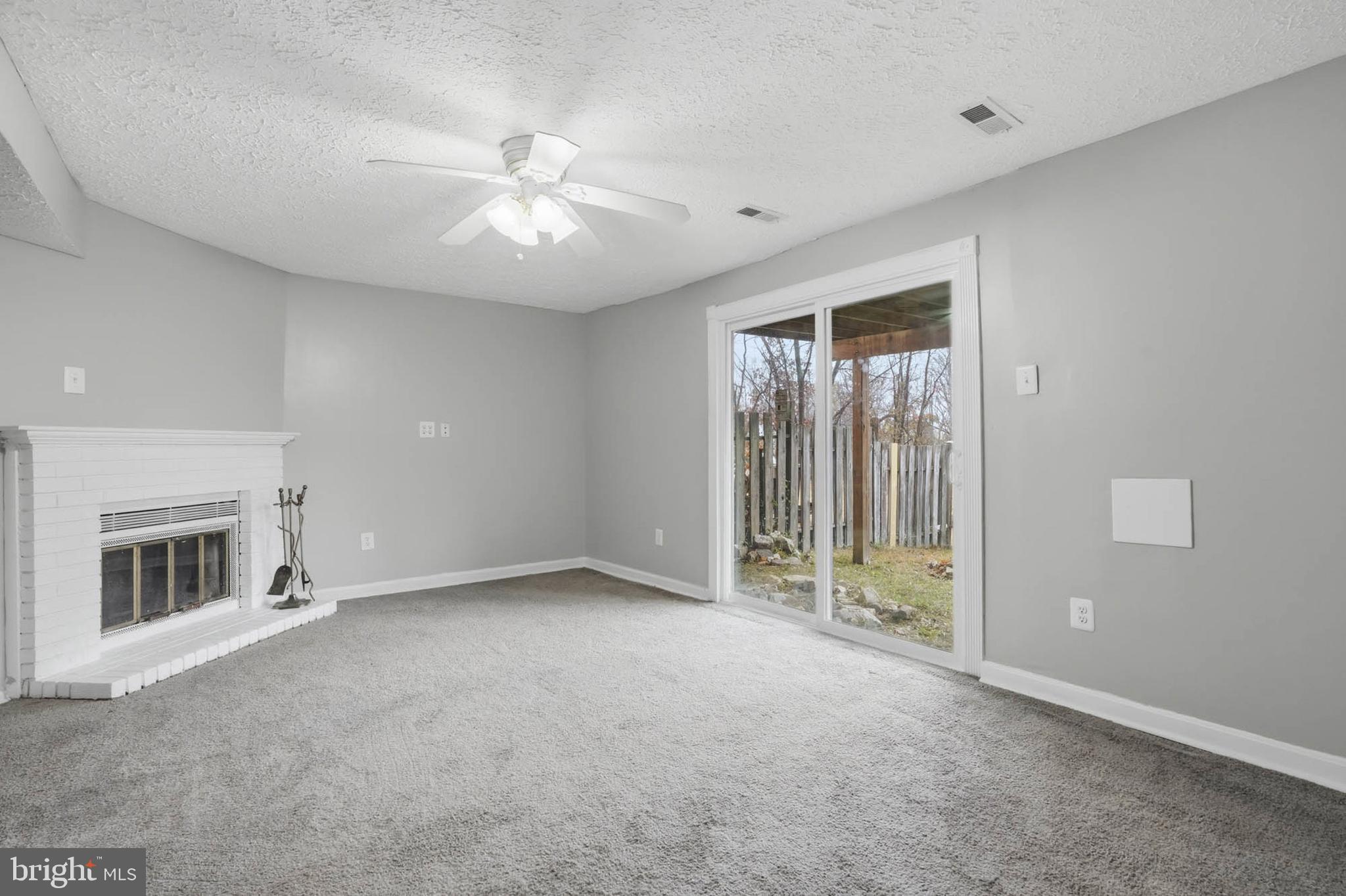 9931 Tuscarora Road Randallstown, MD 21133 - Photo 22 of 30 an empty room with windows and ceiling fan